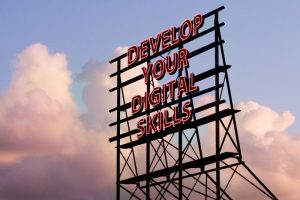 Neon sign which reads "Develop your Digital Skills"