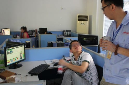 Factory officers watching the recorded World Cup online during lunch break in their office. photo by Xinyuan Wang