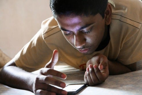 Indian teenager using smartphone