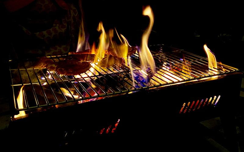 Fires lick over a barbecue.
