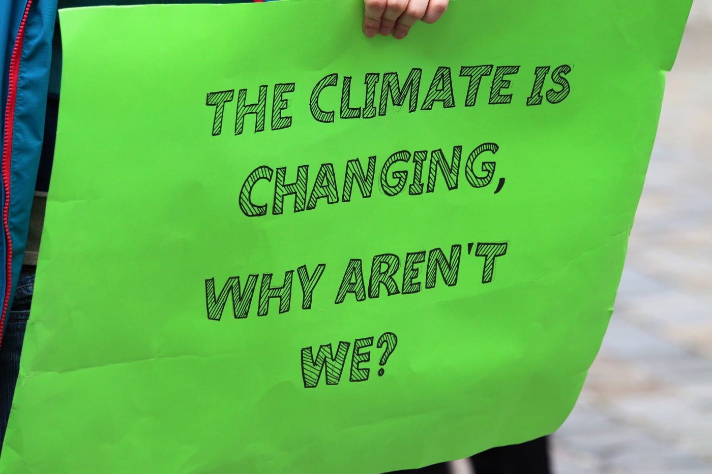 A sign with the words, "The climate is changing, why aren't we?"
