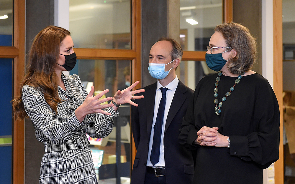 Catherine, Duchess of Cambridge, gestures as she speaks to two researchers during a 2021 visit to UCL.