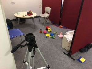 The picture shows the setting of an ADOS: participants were asked to play with different toys and their responses were noted down and later assessed by an ADOS-trained expert.