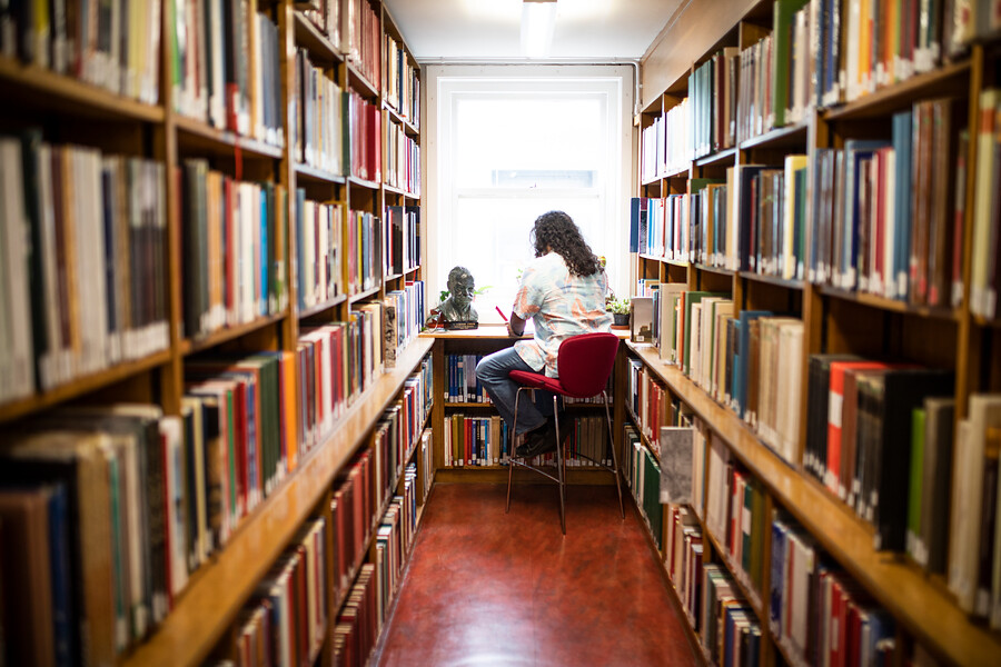 A student studying in a library at UCL. credit: Mat Wright