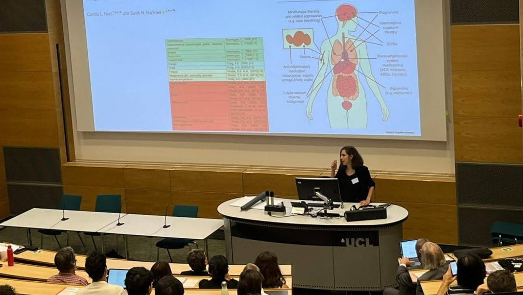 Professor Sarah Garfinkel delivering a presentation on how our ability to sense internal contexts and signals, known as interoception, IoMH Conference at UCL. (credit: Qiyu Xia)