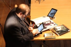 Dr Emmett Sullivan studying his iPads and his books during a break in filming