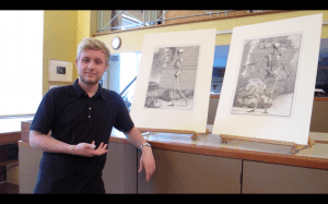 UCL Student Tom Cowie stands in front of two 18thC anatomical prints from the Art Museum's collections