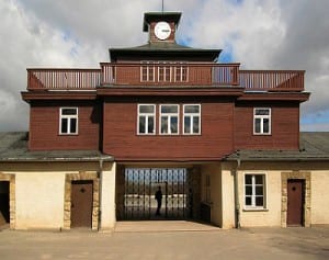 Buchenwald concentration camp. The clock above the entrance permanently records the time of the camps liberation - 3.15. " Buchenwald - Concentration Camp Gate " by Andreas Trepte - Own work . Licensed under CC BY- SA 2.5 via Wikimedia Commons.