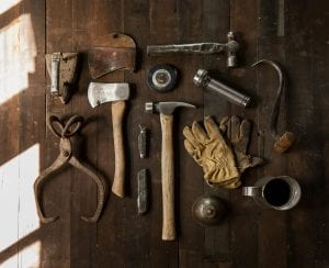 Various gardening tools arranged on a dark wooden background