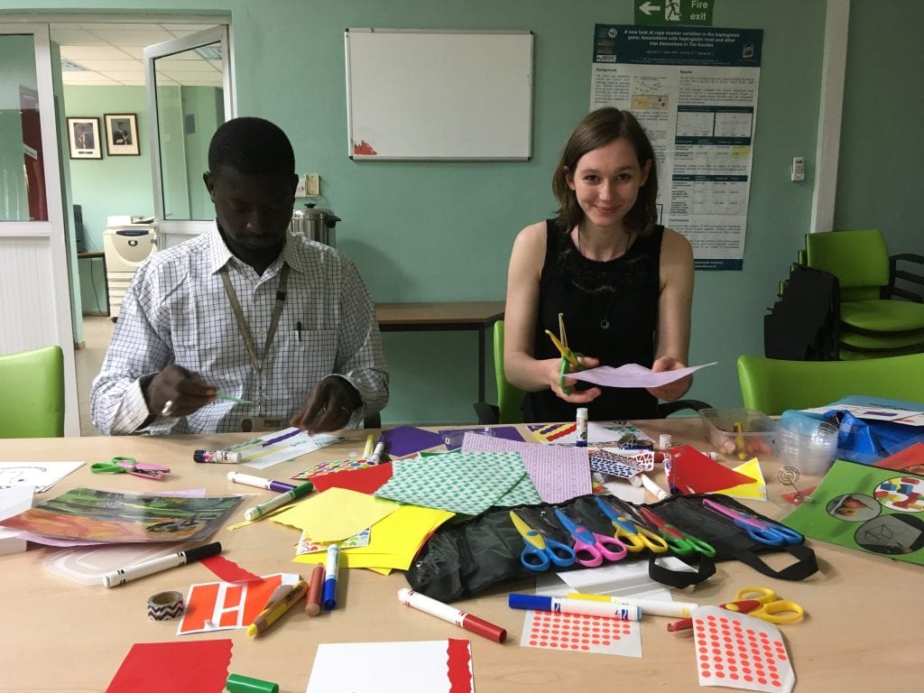 team leaders prepare brightly coloured paper for a visual development workshop