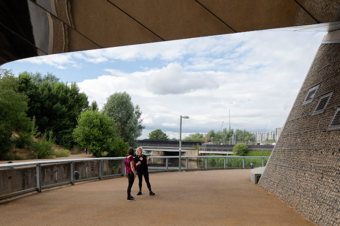 Georgia and Briony converse under a bridge in the Olympic Park