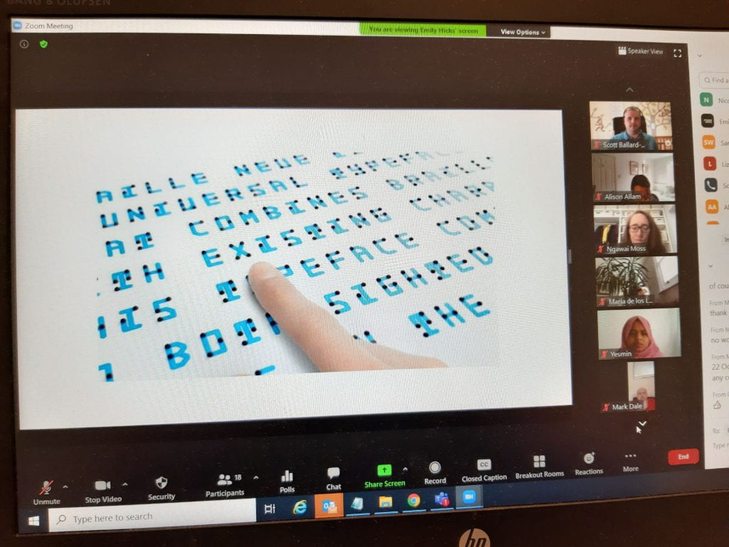 A Zoom call screen with an image of words with braille superimposed on the words