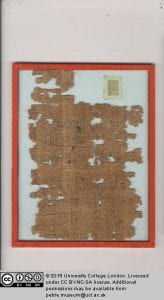 Remains of papyrus showing the division of 2, written in Hieratic script.