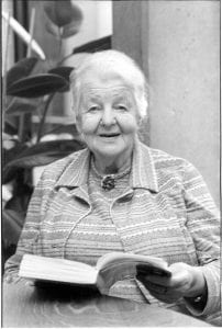 Photograph of Grace Wacey holding a book