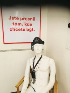 Notice in Czech and mannequin wearing pirate hat.