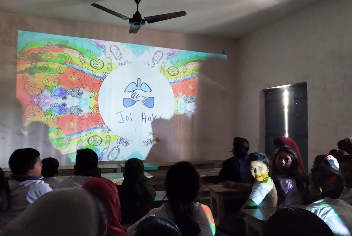 Photo of children watching a Joi Hok presentation