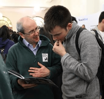 An employer talking to a student at a careers fair