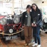 Two students by a vintage car